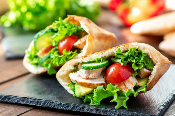 Pita stuffed chicken, tomatoes, lettuce and cucumber. Pita stuffed chicken, tomatoes, lettuce and cucumber. Delicious Mediterranean food. Middle Eastern cuisine. pita bread stock pictures, royalty-free photos & images