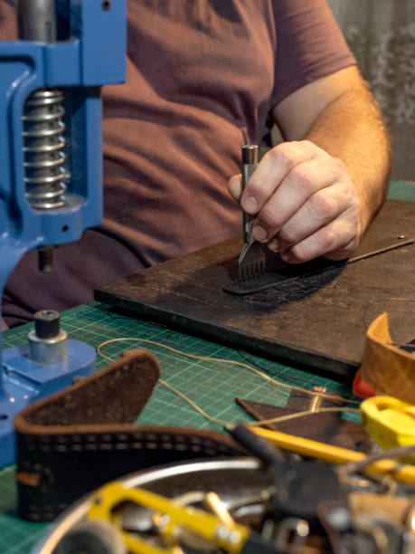 istock Punching holes in a leather belt 1171166786