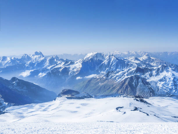 istock Snow-white mountain peaks in clouds 1171166912