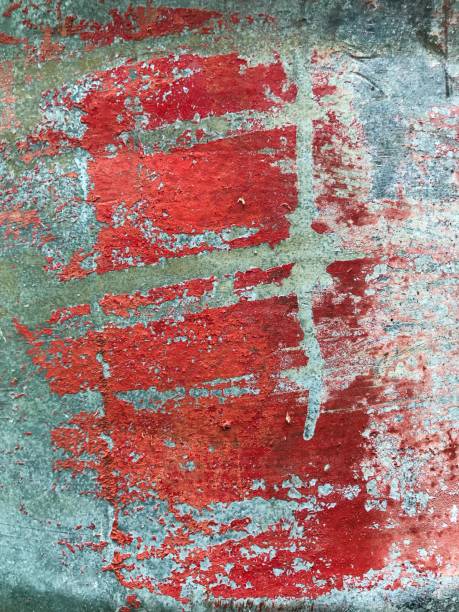 istock Red wall with peeled paint close up. 1171169685