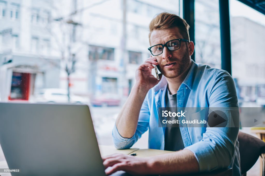 Calling On Computer Young Man Graphic Designer Calling On Smartphone While Working Remotely ...