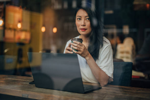 istock Young woman working on laptop in cafe 1171170052