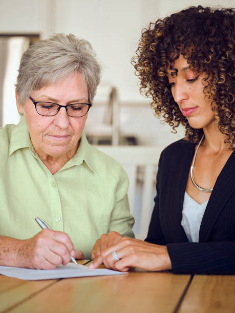 istock Senior Woman Signing Documents in Her Home 1171173627