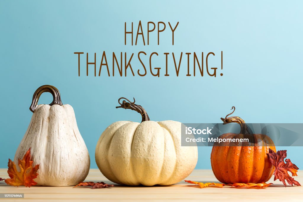 Thanksgiving message with pumpkins Thanksgiving message with pumpkins on a blue background Thanksgiving - Holiday Stock Photo
