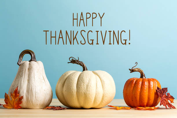 Thanksgiving message with pumpkins Thanksgiving message with pumpkins on a blue background happy thanksgiving stock pictures, royalty-free photos & images