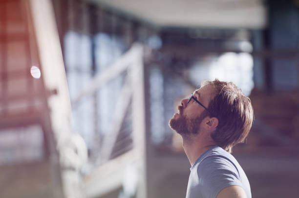 istock young active beautiful bearded working american man in eyeglasses looking up indoors 1171175025