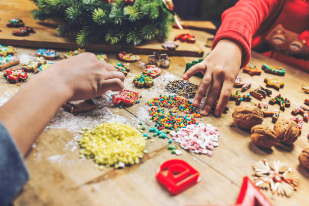 istock kids hands decorating christmas cookies together 1171175115