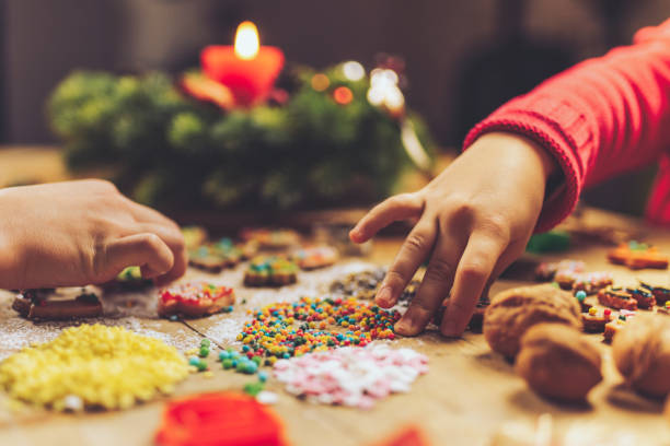 istock kids hands decorating christmas cookies together 1171175184
