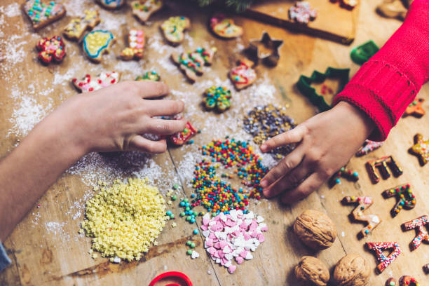 istock kids hands decorating christmas cookies together 1171175231