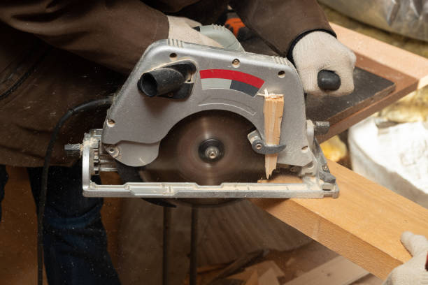 istock Man works as a carpenter with circular saw in his workshop 1171177020