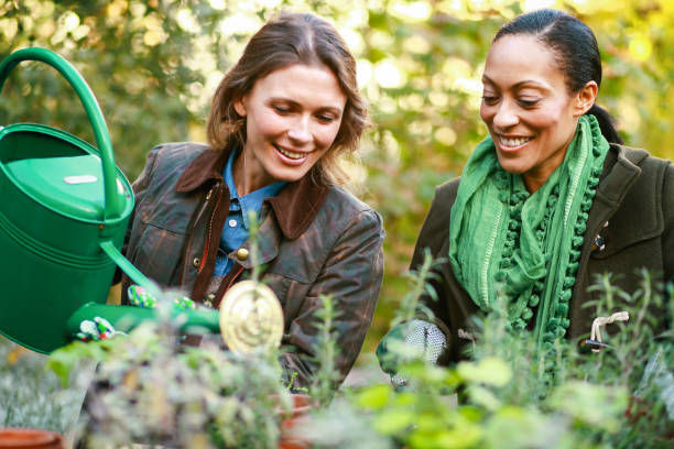 istock Female friends gardening 1171177580