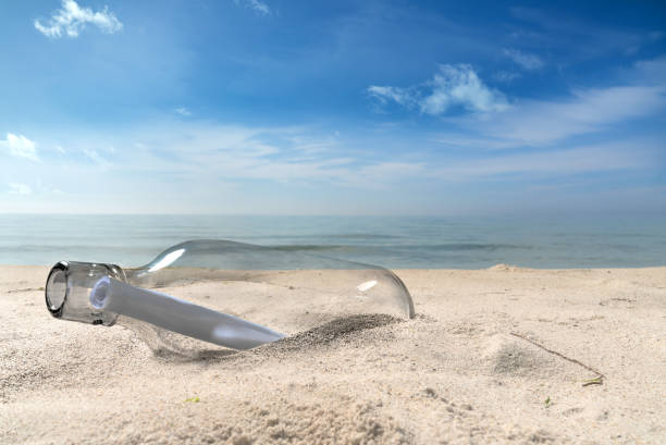 istock a message in a bottle lies on a lonely beach 1171178361
