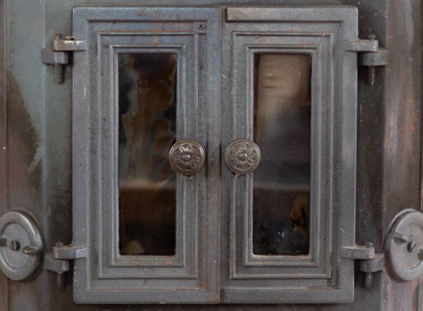 istock Close up old metal fireplace with doors 1171178818