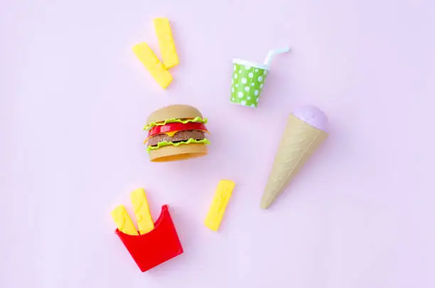 Photo of Toy fastfood food and drink on a pink background.