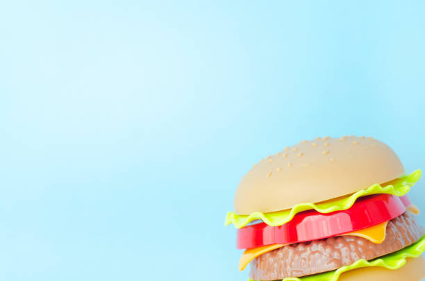 istock Toy burger with meat and salad on an blue background. 1171179883