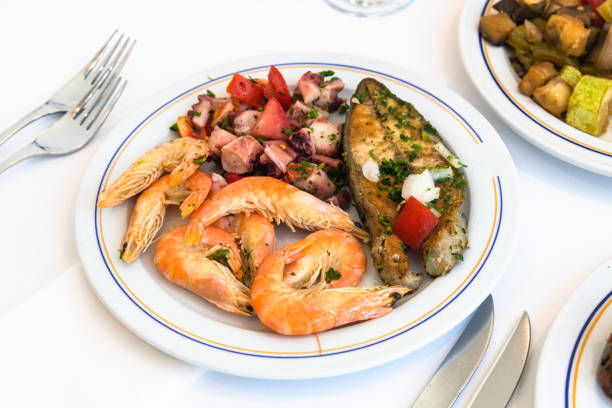 Shrimp, fish and octopus salad on plate in a cafe