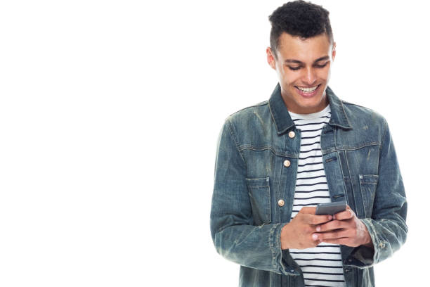 istock Good looking tall black man wearing denim jacket - texting on smart phone 1171181342