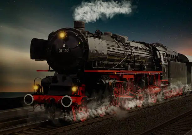 Photo of old steam locomotive at night