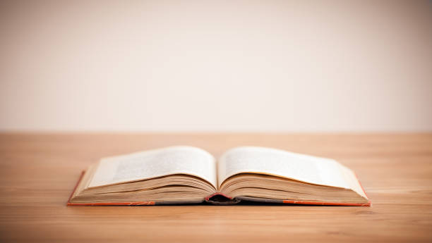 istock Opened book on a wood floor 1171182702