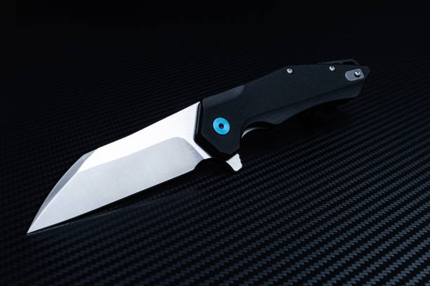 istock Folding pocket knife diagonally. Black background. Shiny blade. 1171183572