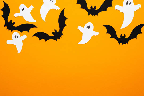 istock Happy halloween concept. Frame of Halloween decorations, bats, ghosts on orange background. Halloween party greeting card mockup with copy space. Flat lay, top view, overhead. 1171184668