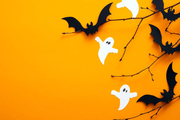 istock Happy halloween holiday concept. Halloween decorations, bats, ghosts on orange background. Halloween party greeting card mockup with copy space. Flat lay, top view, overhead. 1171184710