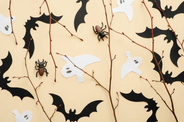istock Happy Halloween concept. Halloween decorations, bats, ghosts, spiders on pastel beige background. Halloween party greeting card. Flat lay, top view, overhead. 1171184764