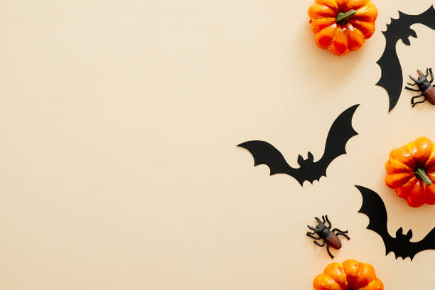 istock Modern Halloween background with pumpkins, spiders, paper bats with copy space for text. isolated on pastel beige background. Flat lay, top view, overhead. Halloween party invitation card mockup. 1171184772