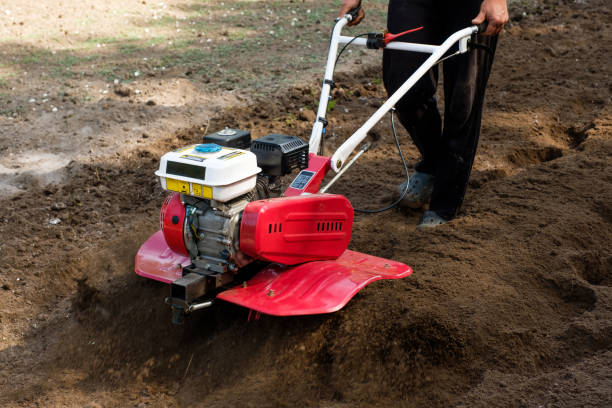 man working in the garden with garden tiller machine. garden tiller to work, close up - grade de lavoura imagens e fotografias de stock
