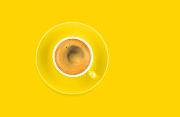 istock One full espresso coffee cup with saucer on yellow 1171184905
