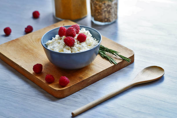 istock Cottage cheese with fresh raspberries in a bowl, healthy breakfast 1171184911