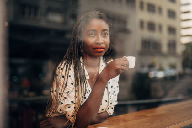 istock Young woman drinking coffee at the cafe 1171186034