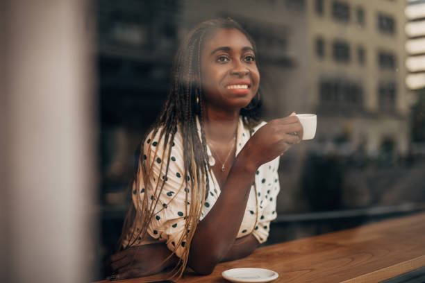 istock Young woman drinking coffee at the cafe 1171186094