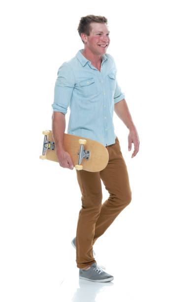 istock Casual well dressed man walking with a skateboard 1171186577