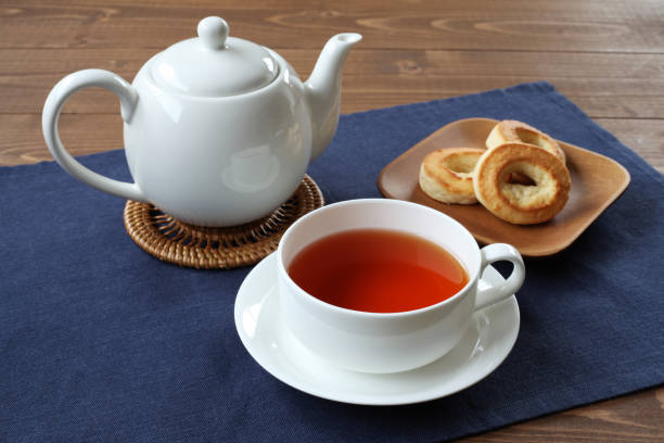 istock cup of tea with ring scone biscuit on plate with isolated on table 1171188067