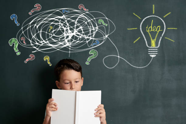 istock 6-7 years child is finding solution on front of blackboard 1171188986