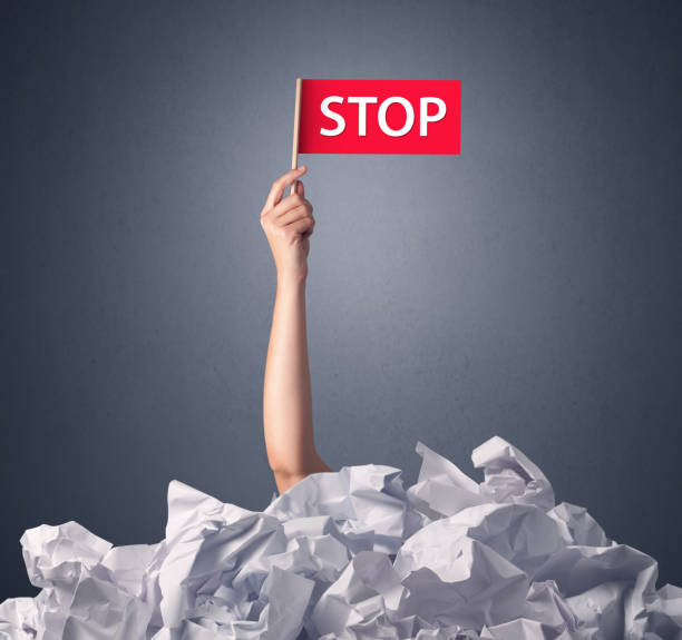 istock Female hand holding stop sign 1171188990