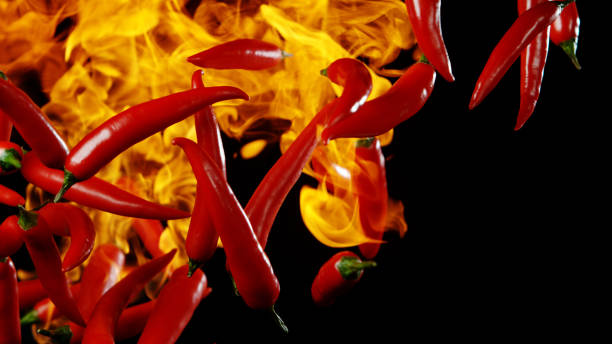 istock Flying red hot chilli peppers with flames 1171189180