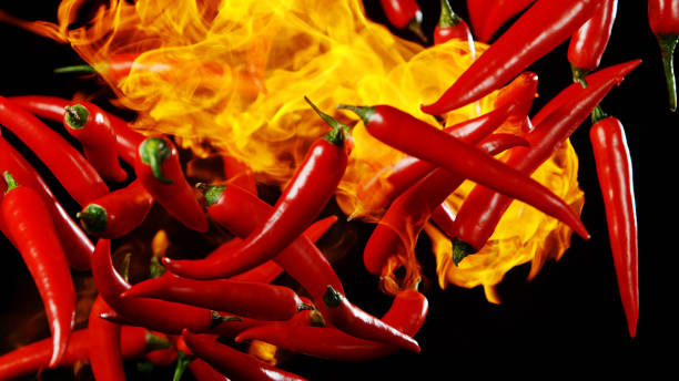 istock Flying red hot chilli peppers with flames 1171189209