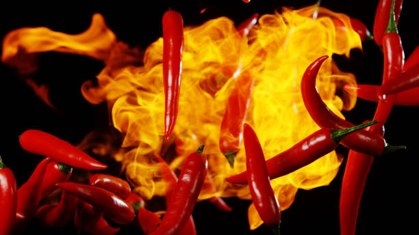 istock Flying red hot chilli peppers with flames 1171189228