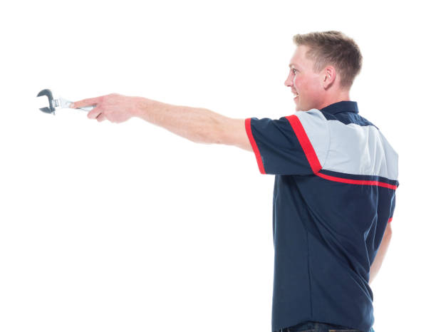 istock Young handsome male mechanic standing on white background - pointing 1171190133