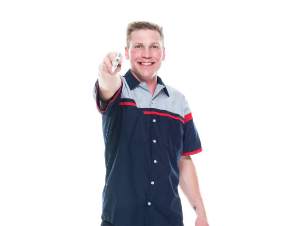 istock Young handsome male mechanic standing on white background - pointing 1171190152