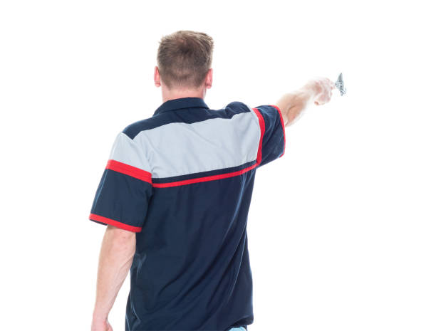 istock Young handsome male mechanic standing on white background - pointing 1171190379