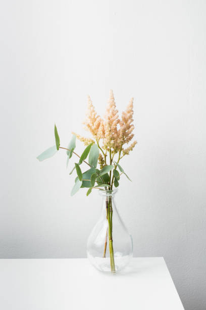 istock Small bouquet of flowers in vase on white table 1171192063