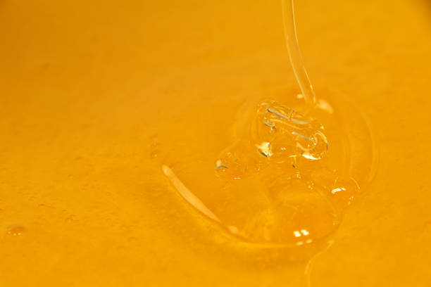 istock Close up pouring fresh fluid honey in bowl 1171194986