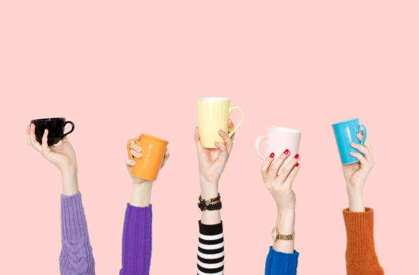 istock Many different arms raised up holding coffee cup 1171195500