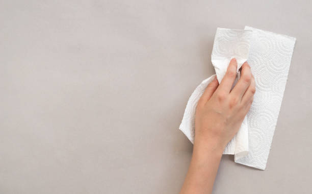 istock Woman wiping table with paper towel 1171195513