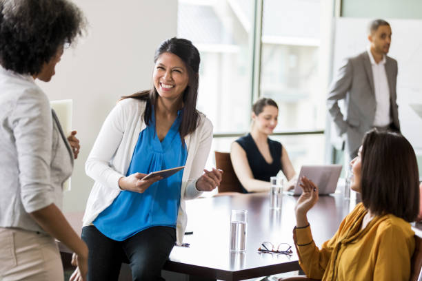 istock Smiling female executive talks with colleague 1171196549