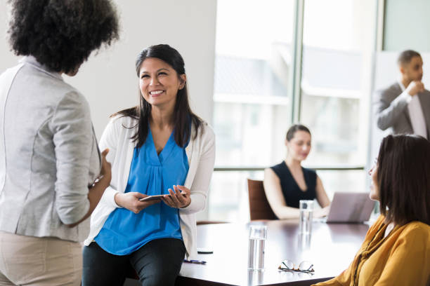 istock Smiling woman talks withe colleague after meeting 1171196551