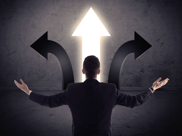 istock Businessman in front of three arrows 1171196621
